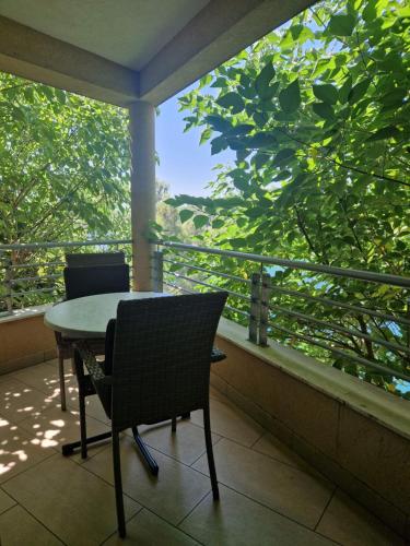 a table and chairs on a balcony with a view at Mystica - charming studio apartment on the beach in Kruševo