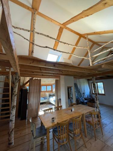 a dining room with a wooden table and chairs at Apartmán Půda Lhotka in Klášterec nad Orlicí