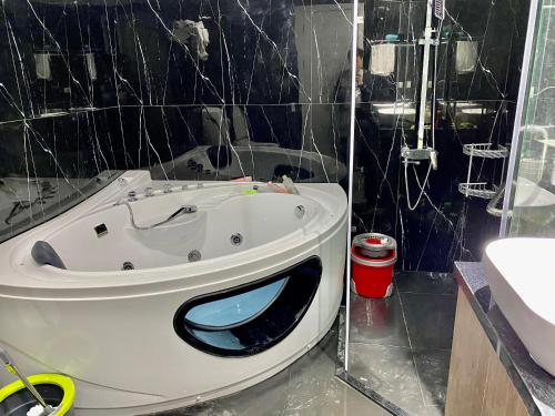 La salle de bains est pourvue d'une baignoire peinte au visage. dans l'établissement 4 Br Villa with cinema luxury, à Hanoï