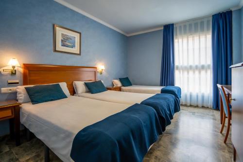 Postel nebo postele na pokoji v ubytování Hotel Bartos