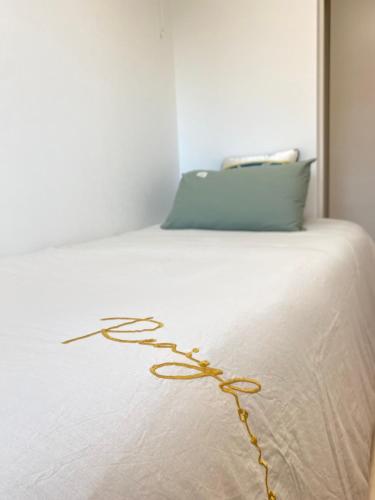 a white bed with a yellow cord on it at Arts Candy Sapporo-Villa Nakajima in Sapporo