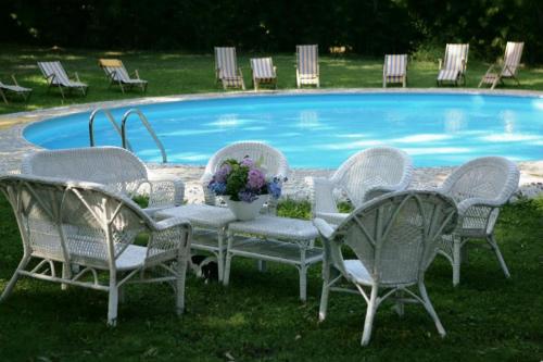 a group of chairs and a table in front of a pool at Casa Portale in Ronciglione