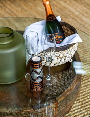 a basket with wine glasses and a bottle of wine at Tsala Treetop Lodge in Plettenberg Bay