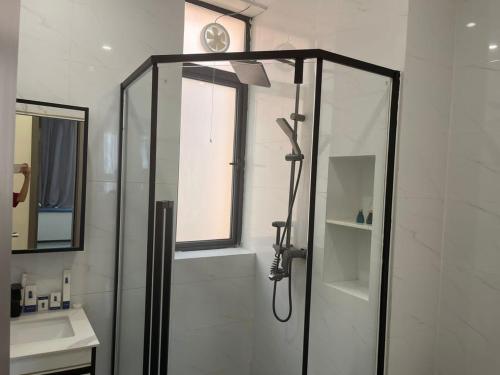 a bathroom with a shower and a sink at Claire Aparthotel in Kigali