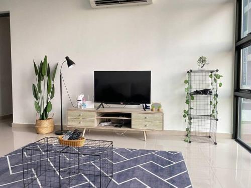 a living room with a flat screen tv on a wall at Recov Guest House, The Square, One City, USJ25 in Subang Jaya