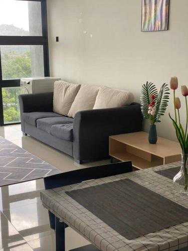 a living room with a couch and a table at Recov Guest House, The Square, One City, USJ25 in Subang Jaya