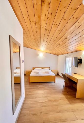 a bedroom with a bed and a desk at Casa Biba in Torri del Benaco