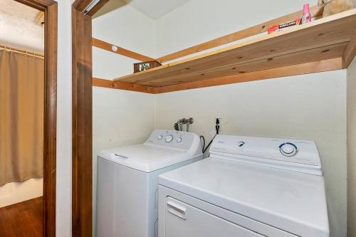 a small laundry room with a washer and dryer at Beautiful 3 BR Cabin/Great Views/Lots of Amenities in Big Bear Lake