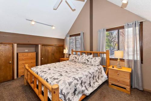 a bedroom with a wooden bed and a window at Beautiful 3 BR Cabin/Great Views/Lots of Amenities in Big Bear Lake