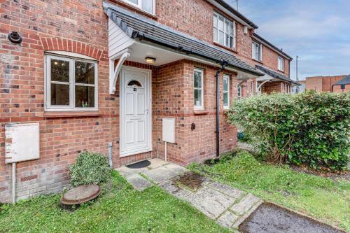 a brick house with a white door and a yard at The Didcot White House in Didcot