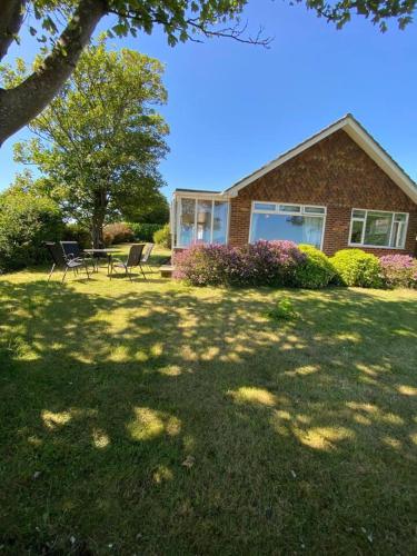 a house with two chairs and a table in a yard at House - Free Parking & Sea Views in Brighton & Hove