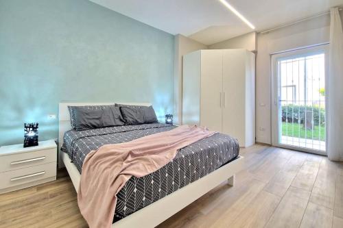 a bedroom with a bed and a large window at [Sogno Marino] Nuovo Appartamento a 150m dal Mare in Porto SantʼElpidio