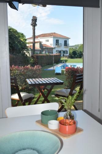 a balcony with a table and a view of a pool at Refugio D Alecrim in Paredes