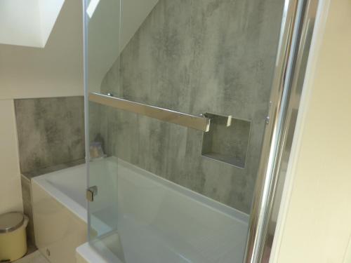 a shower with a glass door in a bathroom at Netherleigh in Willaston