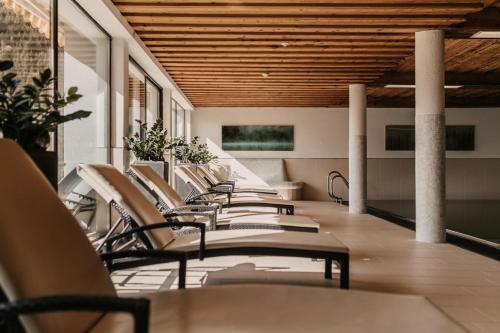 a row of chairs sitting on a balcony at Hotel Neubergerhof in Filzmoos