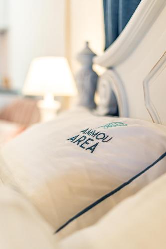 a close up of a bed with a pillow and a lamp at Ammou Area in Ammouliani
