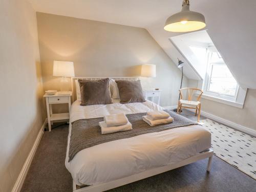 a bedroom with a bed with two towels on it at 12 Westfield Terrace in Saltburn-by-the-Sea
