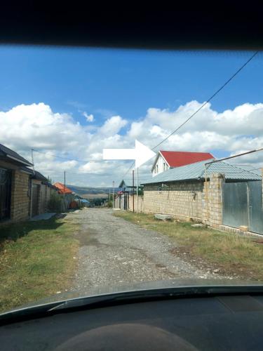 a view from a car window of a dirt road at SUNRISE Guest House in İsmayıllı