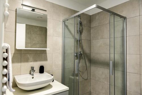 a bathroom with a sink and a shower at Hostel 'SD Palacin' in Šibenik