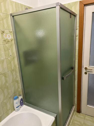 a shower with a glass door in a bathroom at Camere Giulia in Bergamo