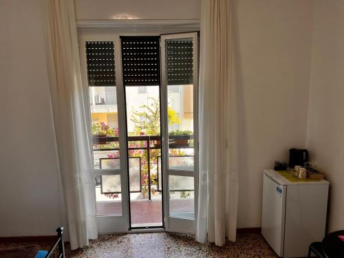 a sliding glass door with a view of a balcony at Camere Giulia in Bergamo