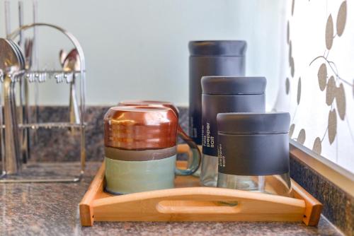 a tray with three coffee cups on a counter at Premier Suites Kyanja in Kampala