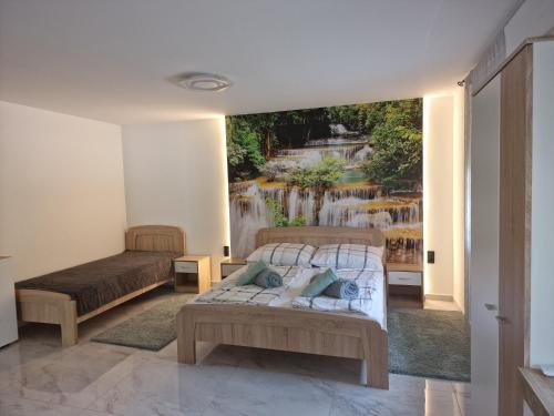 a bedroom with two beds and a mural of a waterfall at Happy House Vendégház in Bogács