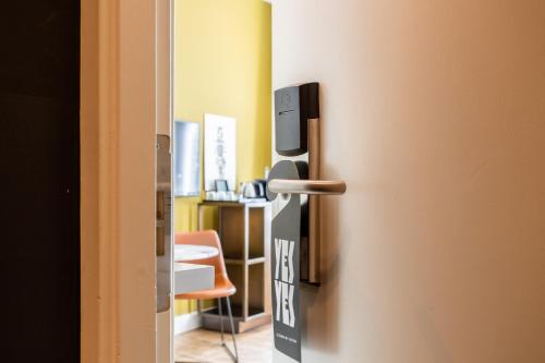 an open door to a room with a chair at Weber Hotel 397 in Amsterdam