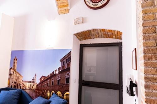 a door in a room with a picture of a city at La Rua in Ascoli Piceno