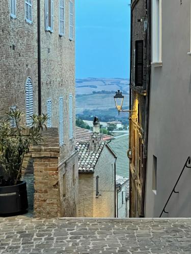 an alley with a view of the water from a building at Casa Rilore in Ostra Vetere