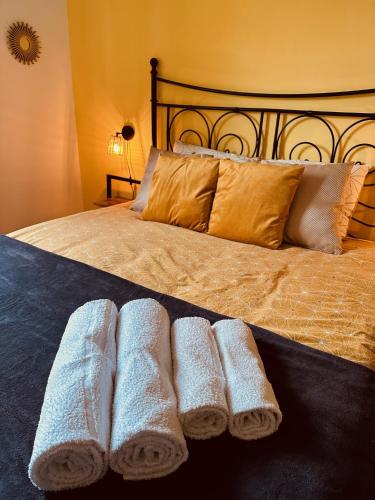 a bed with two rolled towels on it at Casa Rilore in Ostra Vetere