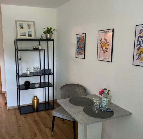a dining room with a table and a shelf at Helpens Hof in Salzhausen