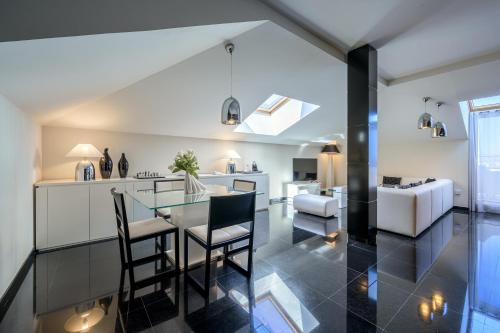 a kitchen and living room with a glass table and chairs at Hotel Nelva in Murcia