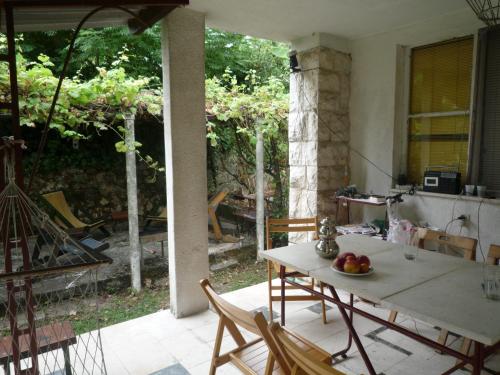 a kitchen with a table and chairs in a room at Vintage Summer House in Budva