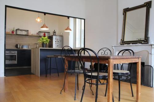 une salle à manger avec une table et des chaises et une cuisine dans l'établissement Noailles experience - Centre Marseille /Vieux-Port, à Marseille