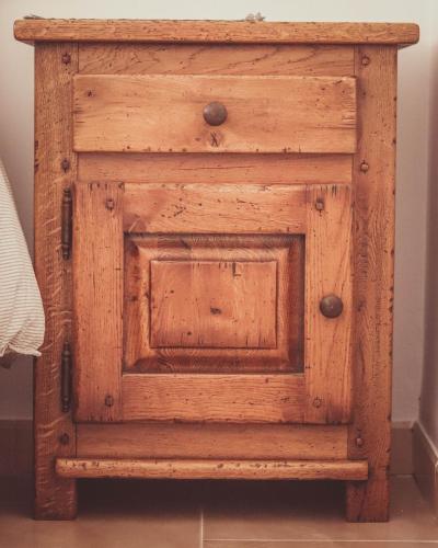 a wooden cabinet with a door in a room at Ca la Tendeta in Tivissa