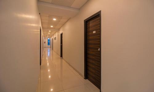 a corridor of a hospital with a door at Treebo Tulip Comfort in Pune