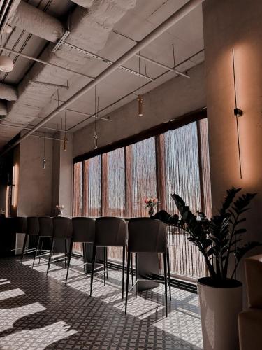 a conference room with chairs and a large window at Ramada Encore Kyiv in Kyiv
