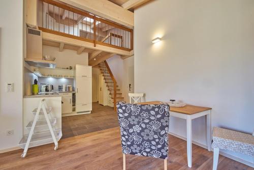 a kitchen and dining room with a table and a chair at Alb Appartements in Albstadt
