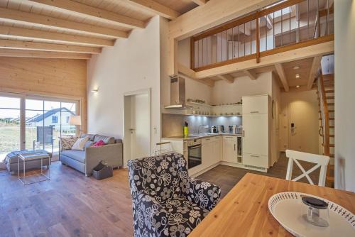 a kitchen and living room with a couch and a table at Alb Appartements in Albstadt