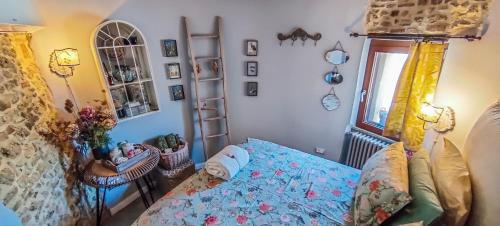 a bedroom with a blue bed and a window at La Torretta in Torrita Tiberina