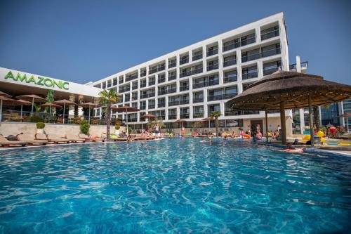 a large swimming pool in front of a building at Hotel Terra in Neptun