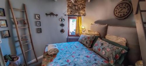 a bedroom with a bed and a clock on the wall at La Torretta in Torrita Tiberina