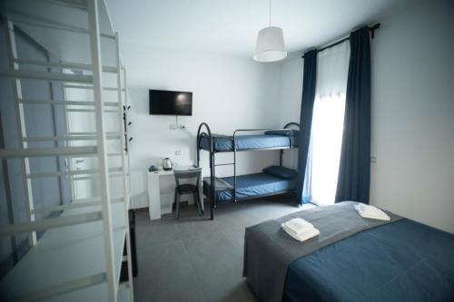 a bedroom with a bunk bed and a ladder at Al Vicolo Comfort Room in SantʼAgata di Militello