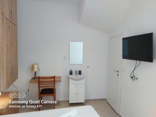 a white room with a sink and a tv at Old Market Studio next to parking lot in Heraklio
