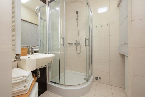 a bathroom with a shower and a sink at Pine House by Sea in Pobierowo