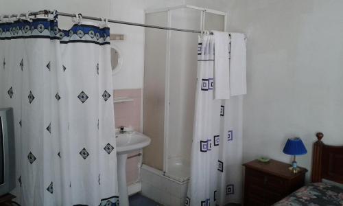 a bathroom with a shower curtain and a toilet at Casa de Hospedes Boa Noite in Lisbon