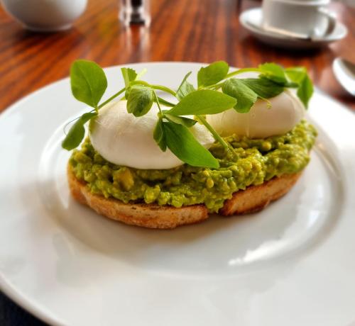 a sandwich with eggs and green peas on a white plate at The Cavendish in Scarborough