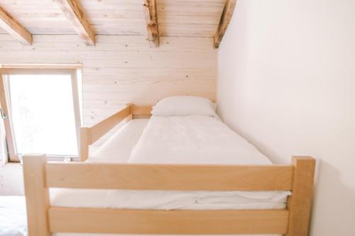 a bed in a small room with a window at Vucja Gora in Foča