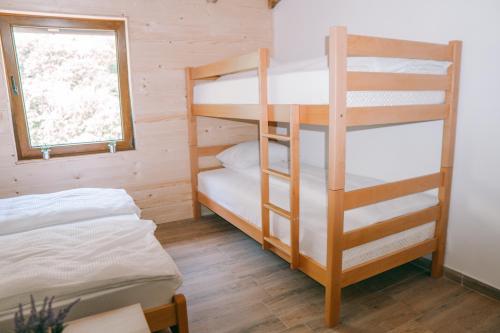 a bedroom with two bunk beds and a window at Vucja Gora in Foča